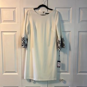 Tommy Hilfiger white dress with black detail on bell sleeves.